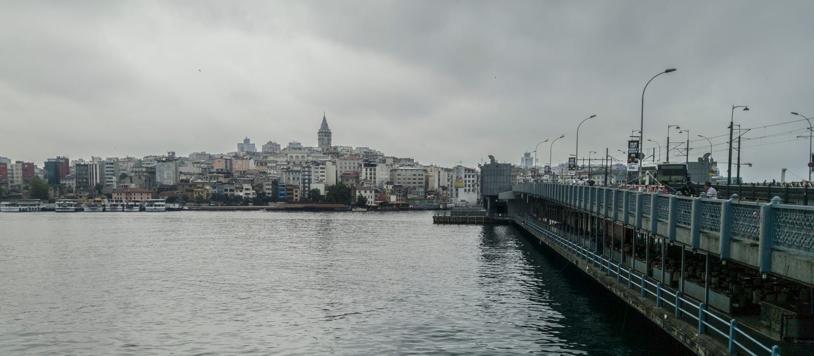 Bulutlu bir günde Haliç üzerindeki Galata Köprüsü ve arka planda Galata Kulesi ile Karaköy yamaçları